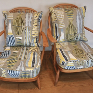 A pair of 1950’s Ercol cottage easy chairs in ‘Hayward’ fabric by Sanderson