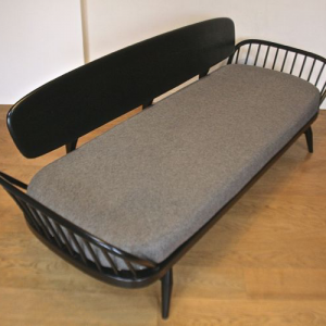 A mid-century Ercol ebonised studio couch/sofa bed