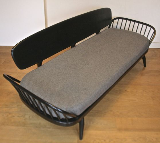 A mid-century Ercol ebonised studio couch/sofa bed