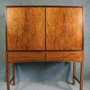 A tall 1950s walnut cabinet