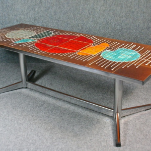 A 1960s abstract tile topped and chrome coffee table
