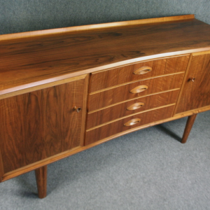 A 1950’s curve fronted sideboard by W H Russell for  Gordon Russell