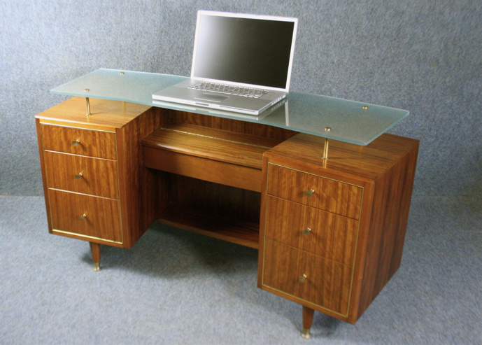 A 1950’s kneehole desk or dressing table by Claude Gibbs for Herbert Gibbs