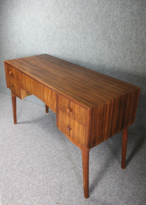 A 1950’s teak and zebra wood desk