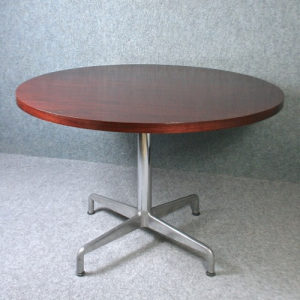A 1970’s circular rosewood and chrome dining table
