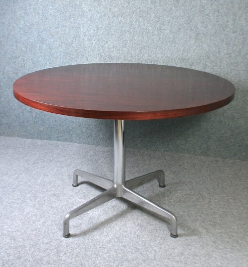 A 1970’s circular rosewood and chrome dining table