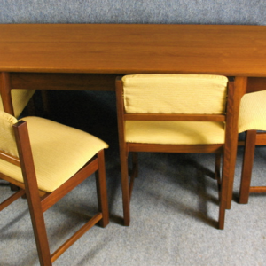 A 1950s folding teak dining table and four chairs