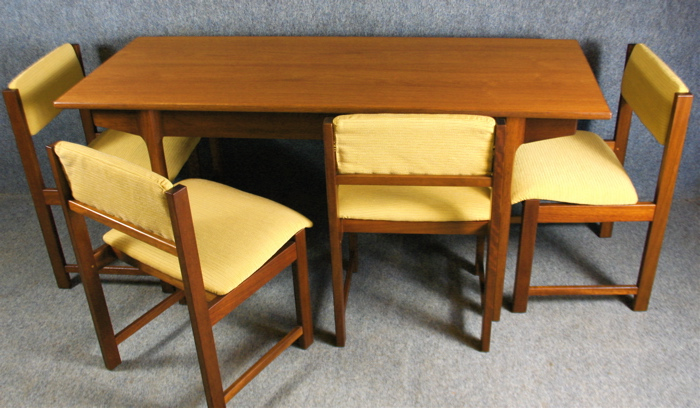 A 1950s folding teak dining table and four chairs