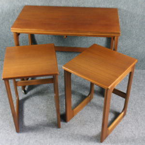 A 1960’s McIntosh mid-century metamorphic dining table nest of teak tables