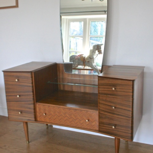 A mid 20th century Uniflex inlaid tola wood dressing table