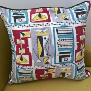 A vintage handmade piped cushion made with rare 1950's fabric.