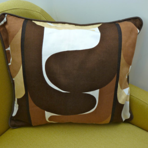 A vintage handmade piped cushion made with rare 1960's fabric.