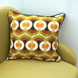 A vintage handmade piped cushion made with rare 1960's fabric.