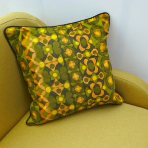 A vintage handmade piped cushion made with rare 1960's fabric.