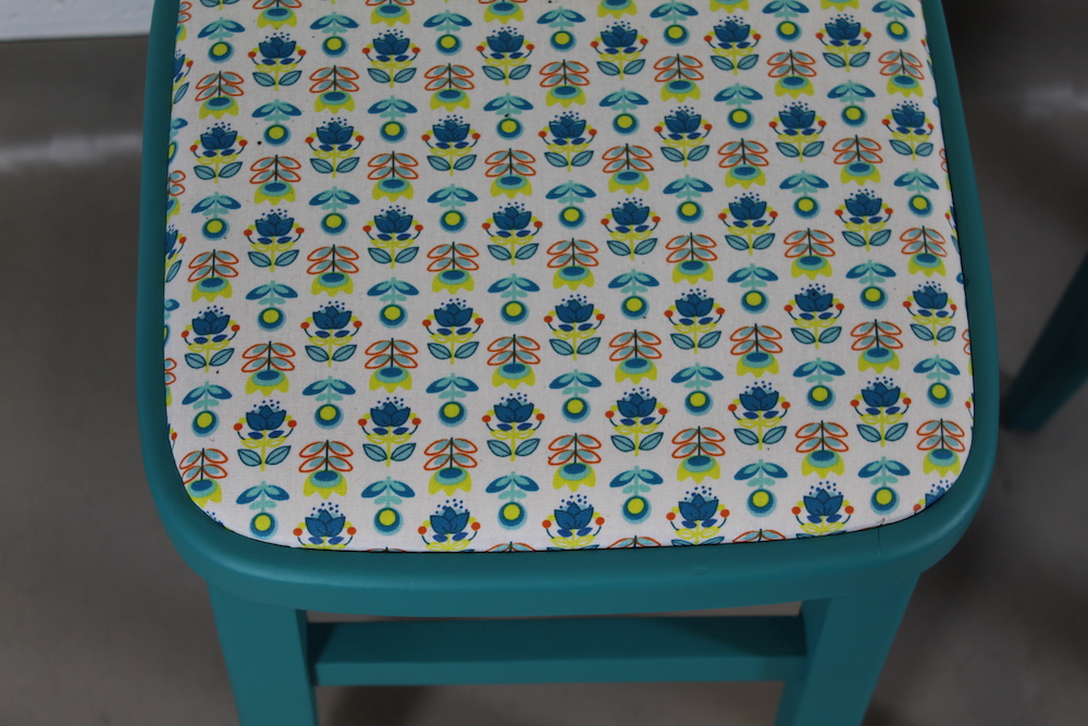 pair of up-cycled turquoise kitchen stools covered in Holly Scandi style oilcloth - Image 2