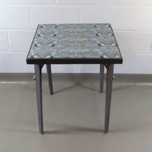 An up-cycled folding occasional table covered in Voyage Nocturnal in seathistle.