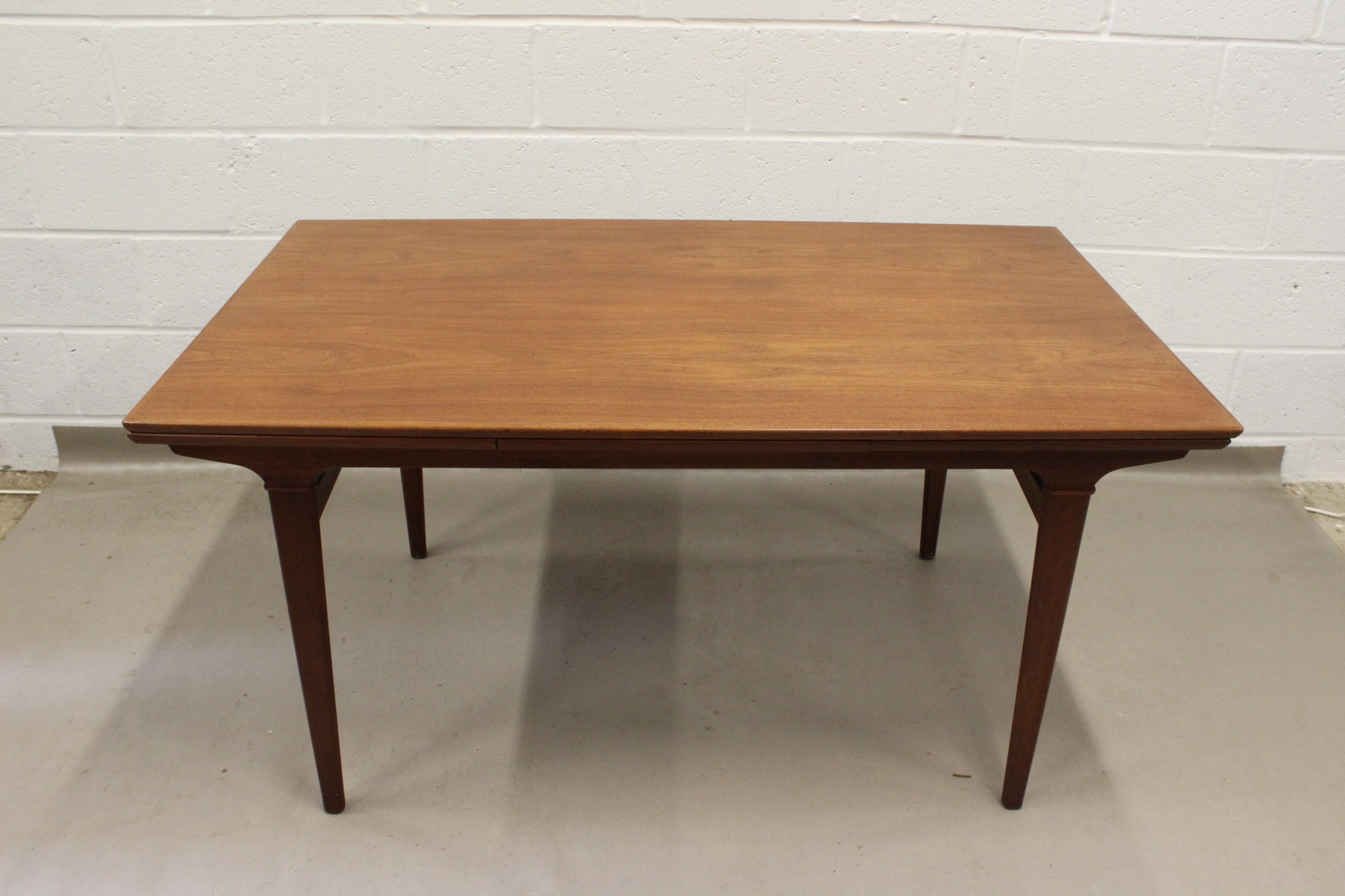 A 1950's Danish teak extending dinning table.
