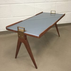 A 1950's teak tray coffee table with brass handles