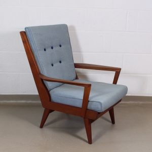 A 1950's Teak wingback chair with blue/ grey linen button back upholstery