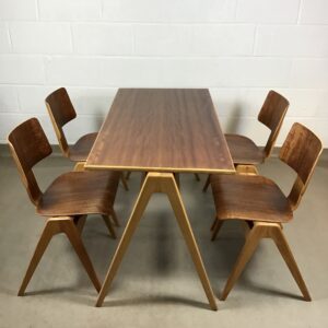 Five 'Hillestak' chairs and a table designed by Robin Day for Hille
