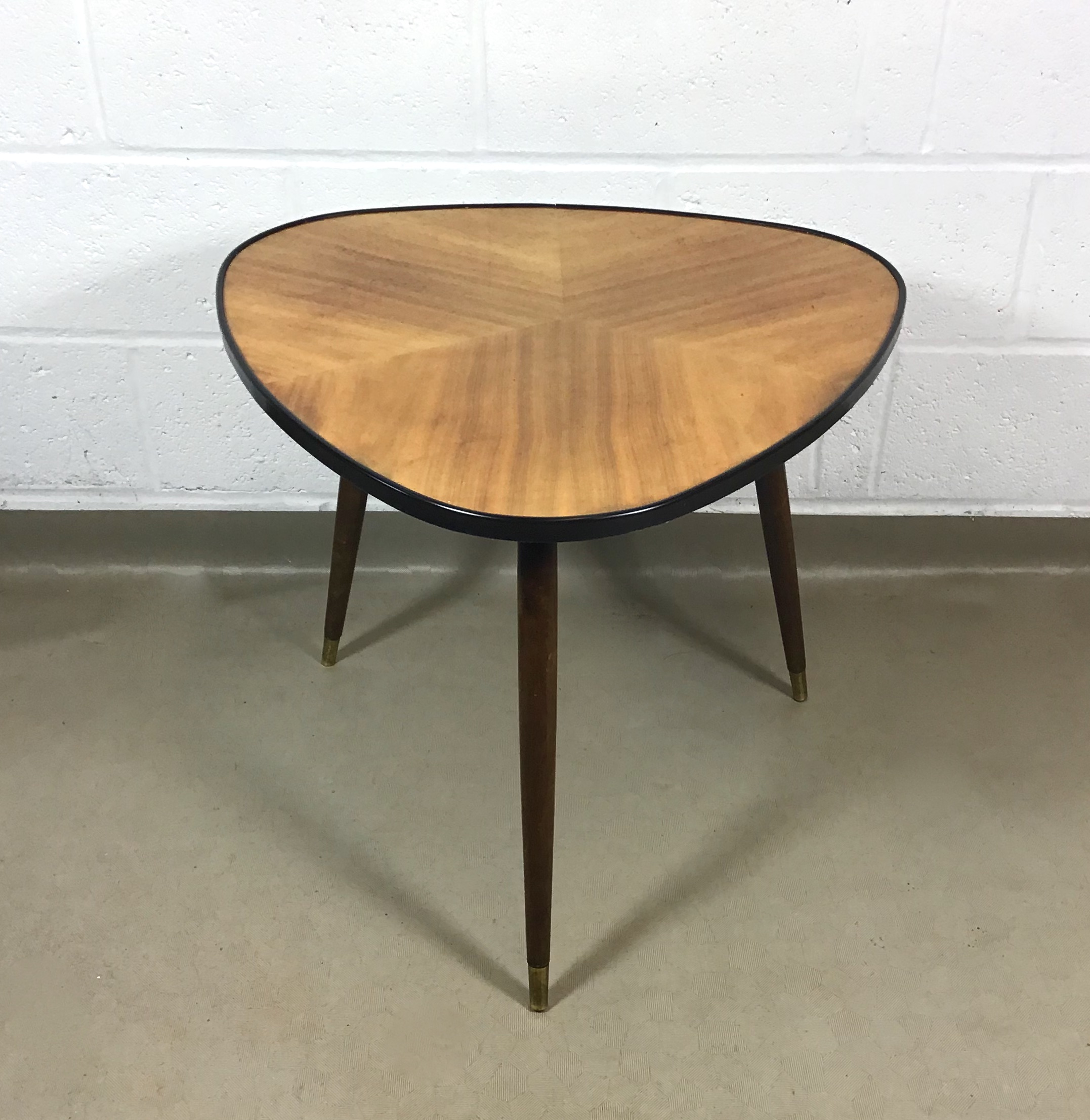 A 1950's marquetry topped high lustre triangular occasional/sofa table