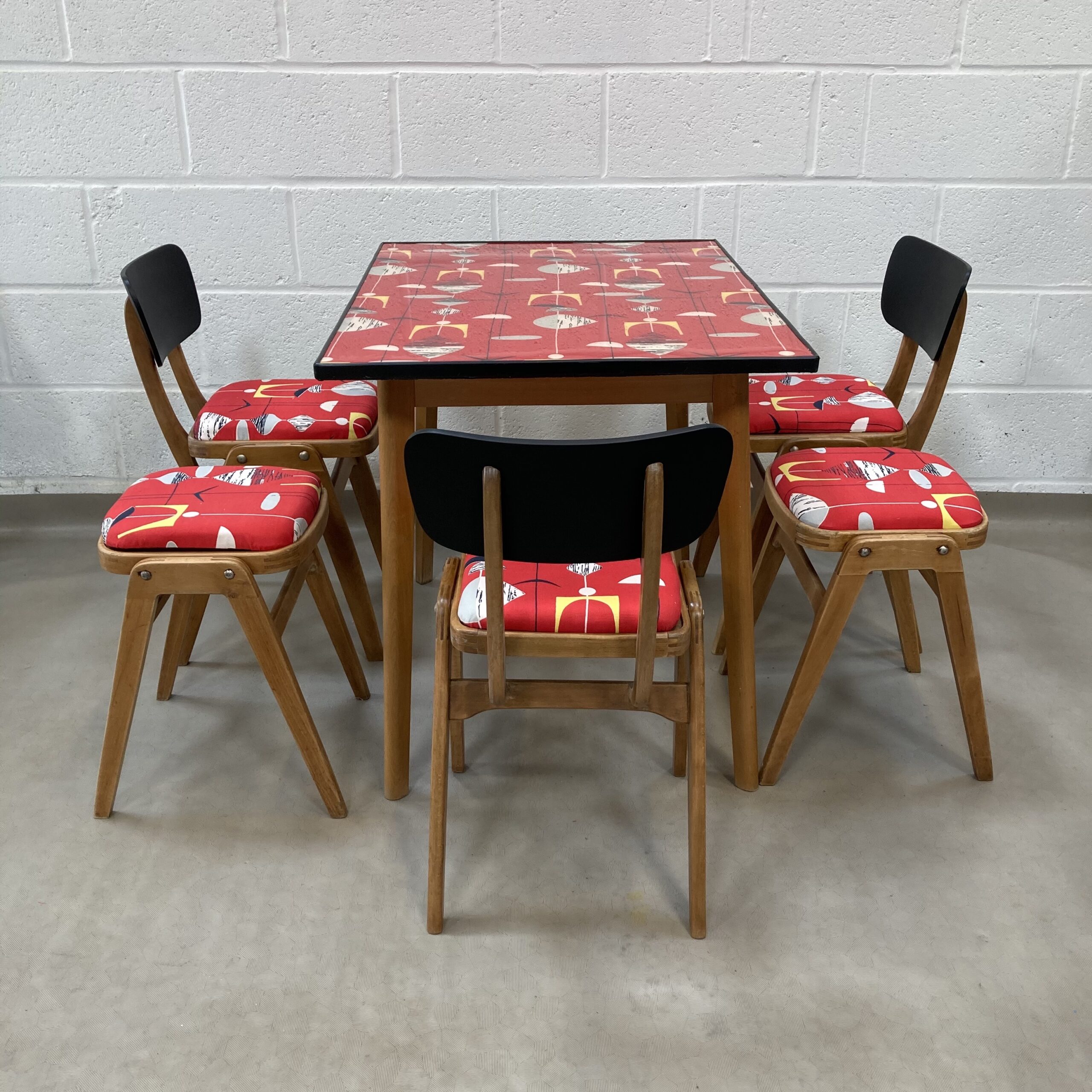 A lovely up-cycled midcentury kitchen dining set decorated in Sandersons Marion Mahler, Red mobiles