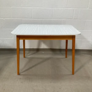 A 1970s grey faux wood grain Formica kitchen table.