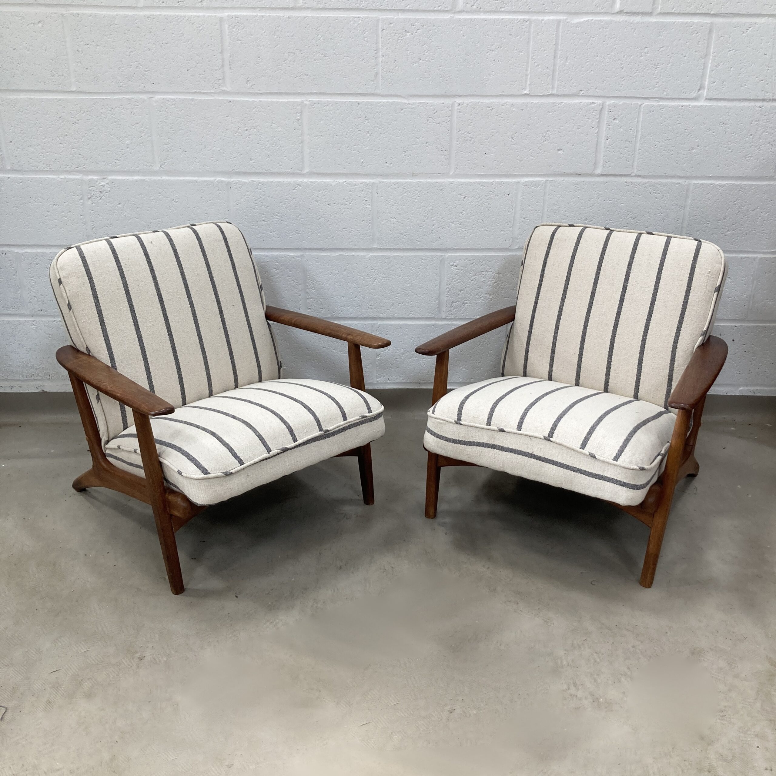 A Pair of Danish Armchair reupholstered in a grey and ecru striped fabric called Mary.