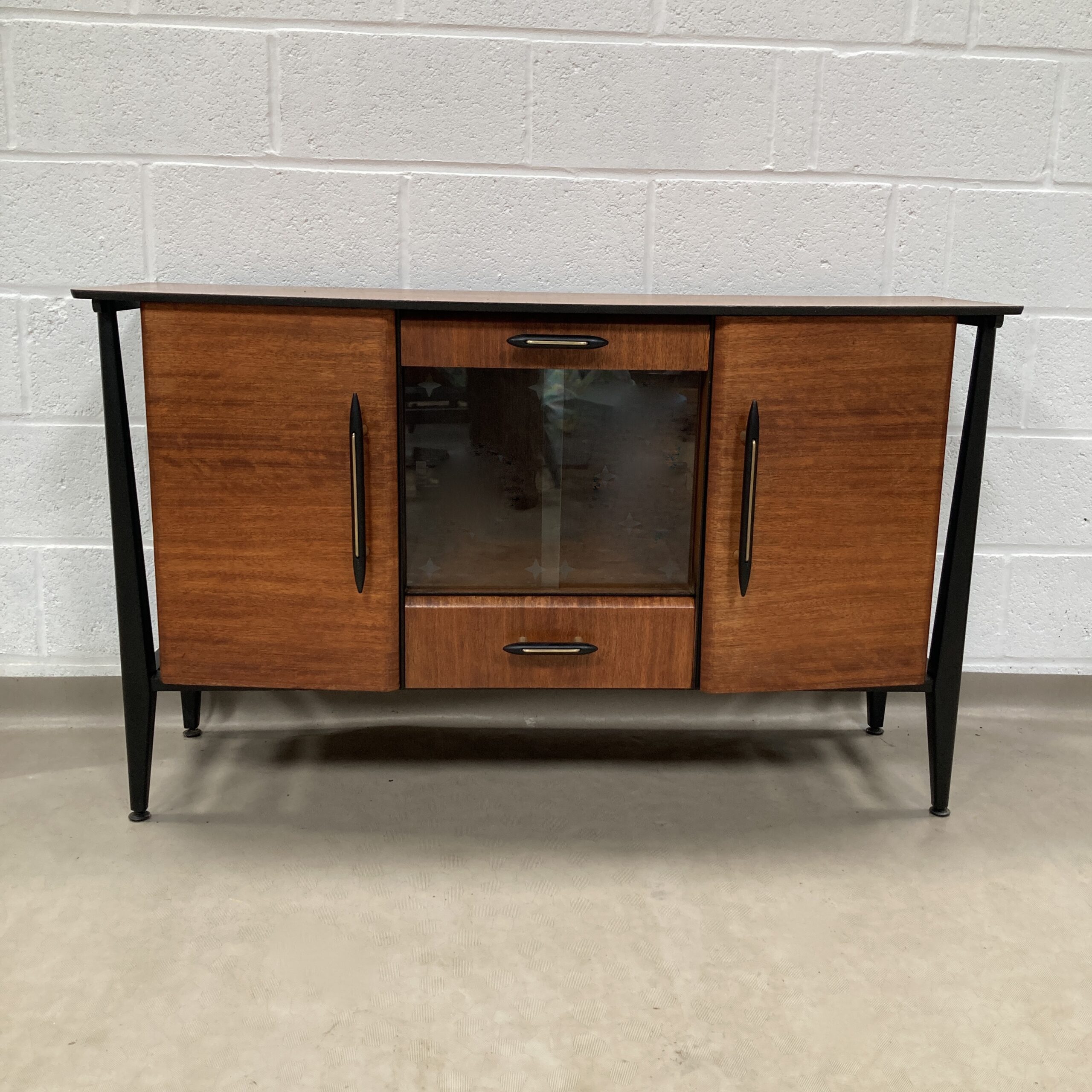 A 1950s Midcentury teak and ebonized sideboard